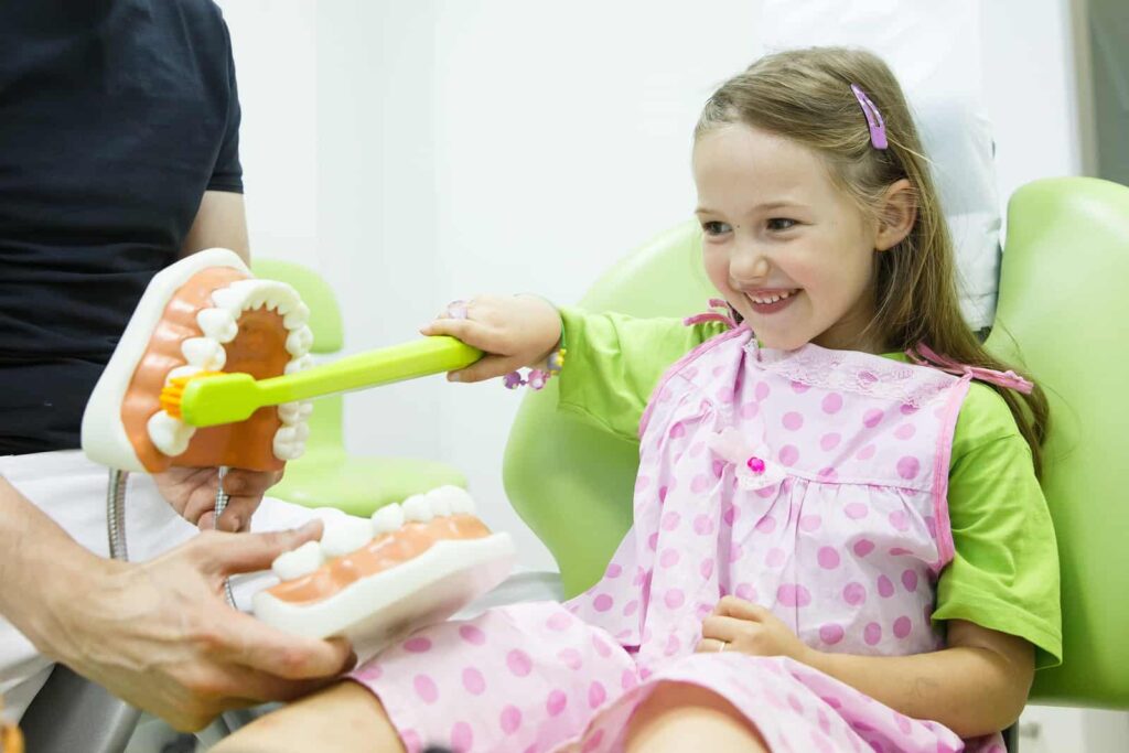 bigstock Girl In Dentists Chair Toothbr 96408167
