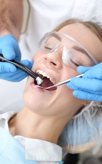 Dentist Examines Teeth of Female Patient — Albany Dental in Gosford, NSW