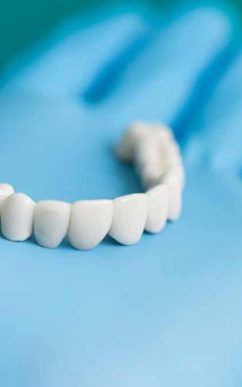 Dentist Showing Dental Bridge To Patient — Dentist In Gosford, NSW