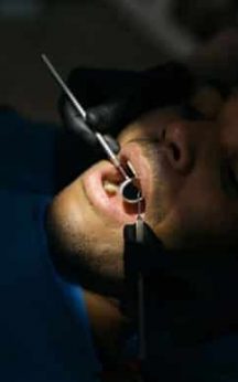 dentist performing check up man