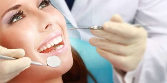 close up dentist performing cosmetic dental work