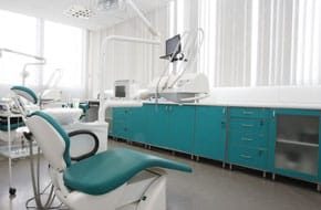 photo of dental clinic with teal cabinets