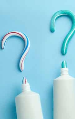 tubes of toothpaste with toothpaste looking like question mark